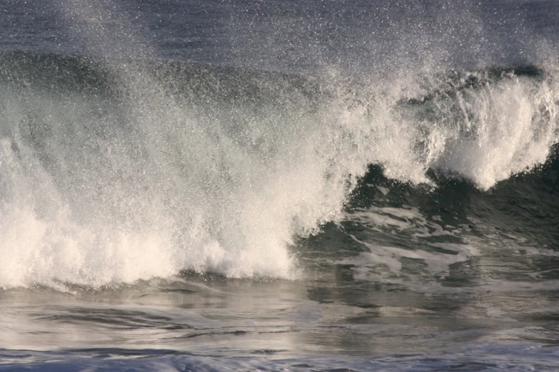 a big wave rolls through in the water