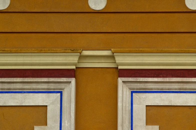 a red and blue stop sign that is next to a building