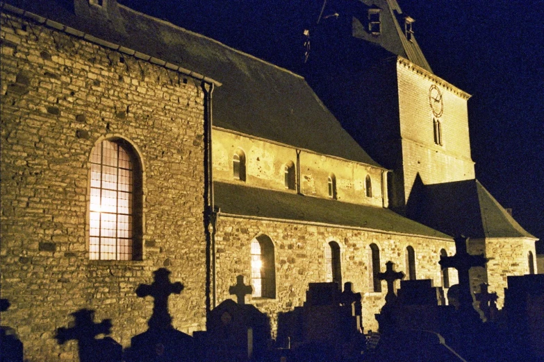 a cemetery with a large building and clock tower in the background