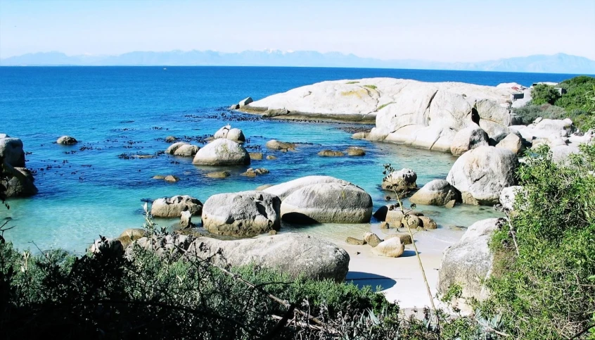 some rocks on the shore of a beach