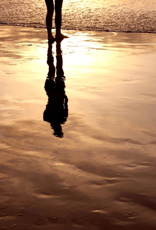 a person with a surf board is walking on the beach