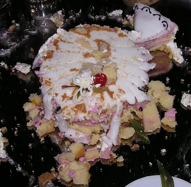 a large white dessert with pineapple and raspberries