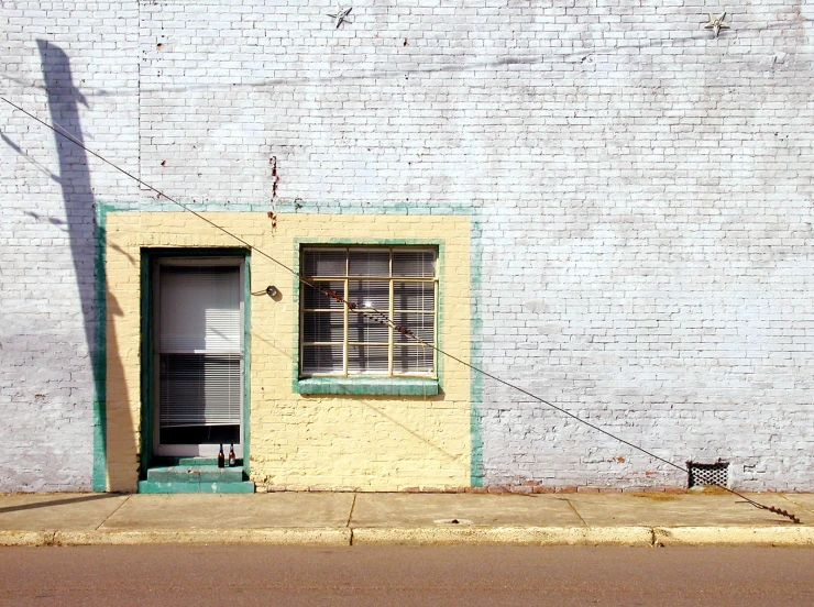 this building is painted yellow, with a small window