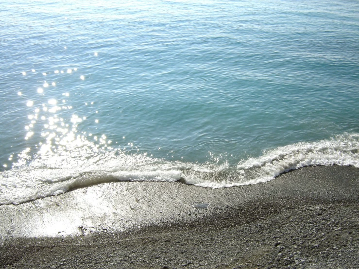 ocean surf splash on the beach with blue sky and white waves