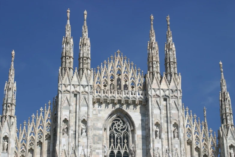 an intricate building made of white stone with a massive door