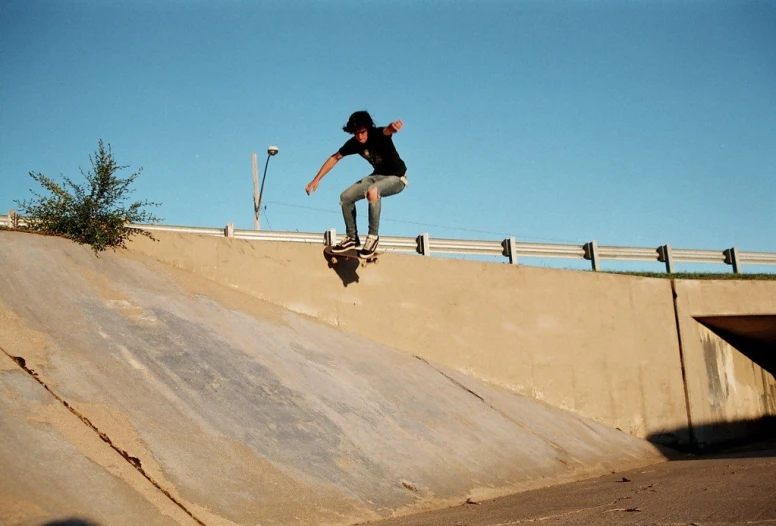 a skateboarder riding down the ramp while doing a trick