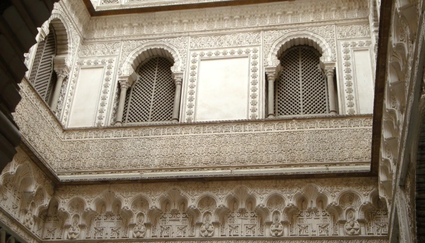 an elaborate architecture is framed by intricate carvings