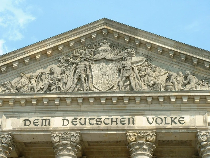 architectural detail, on a building with stone pillars, depicts a coat of arms