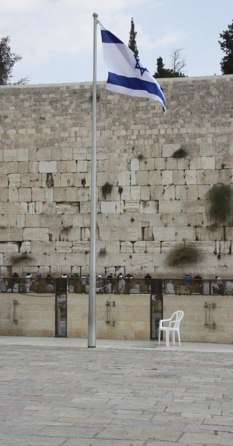 the flag flying by the wall of stones