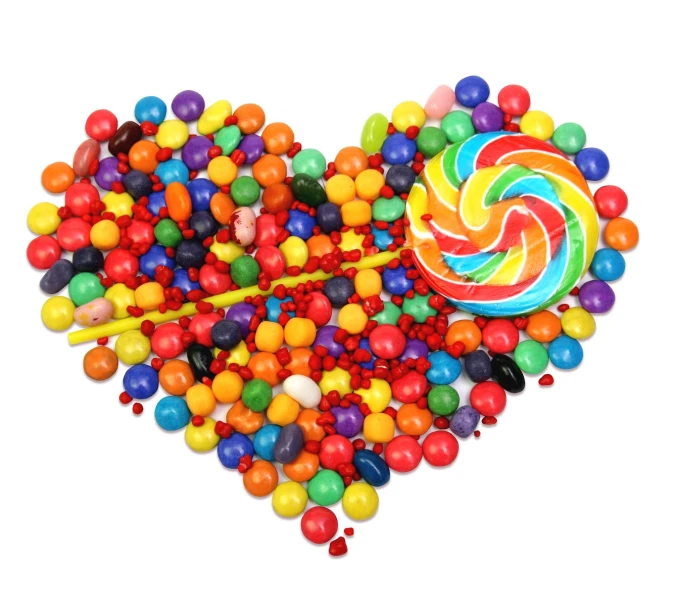 multicolored lollipops inside of a heart shaped candy bowl