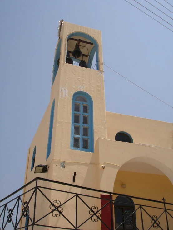 a building with a bell tower and blue windows