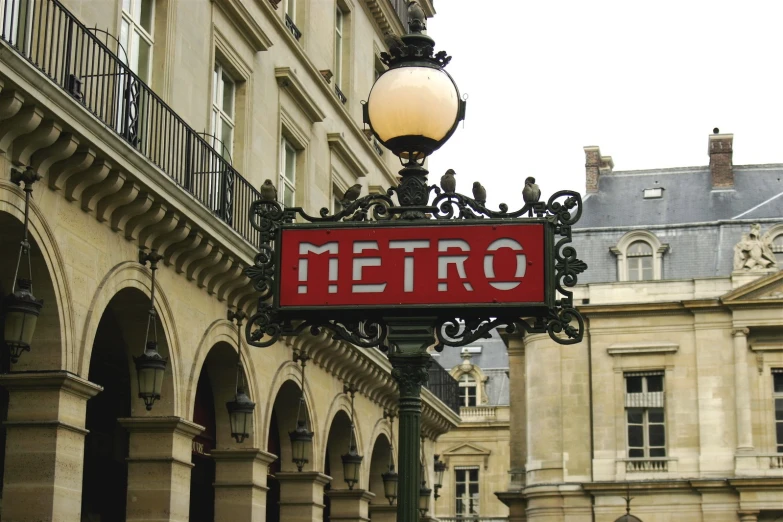 sign for metro in an urban area near a building