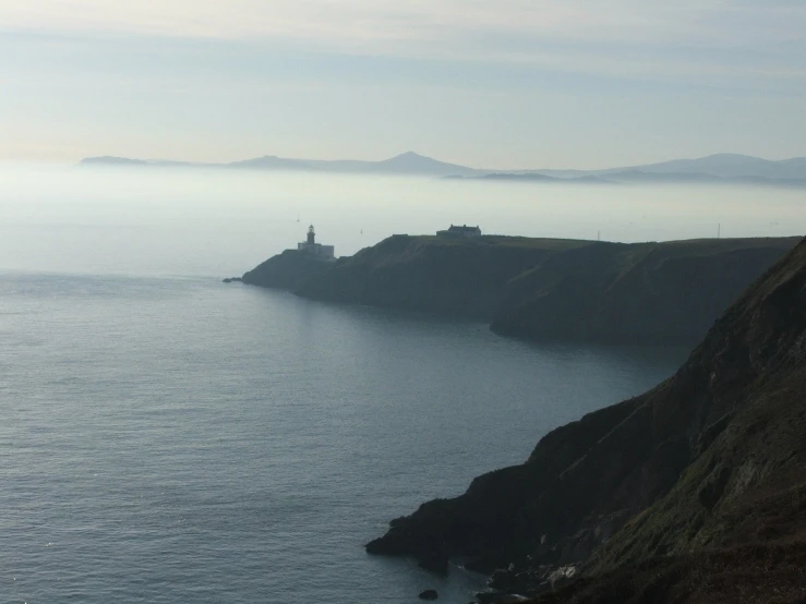 a sea cliff with sea in the background