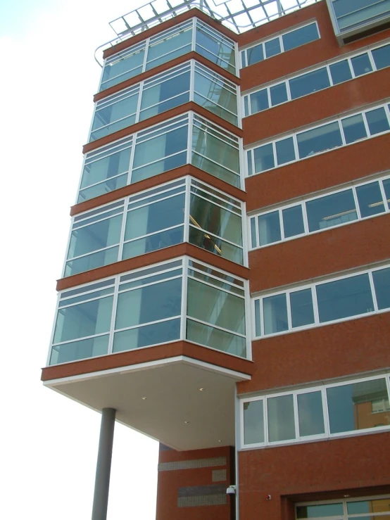 a man in the window of a red brick building