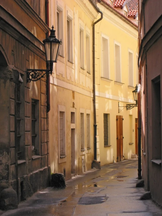 an old narrow street in the evening with its light on