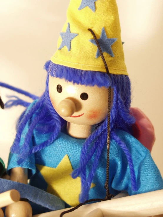 this is a handmade doll with a knitted hat on