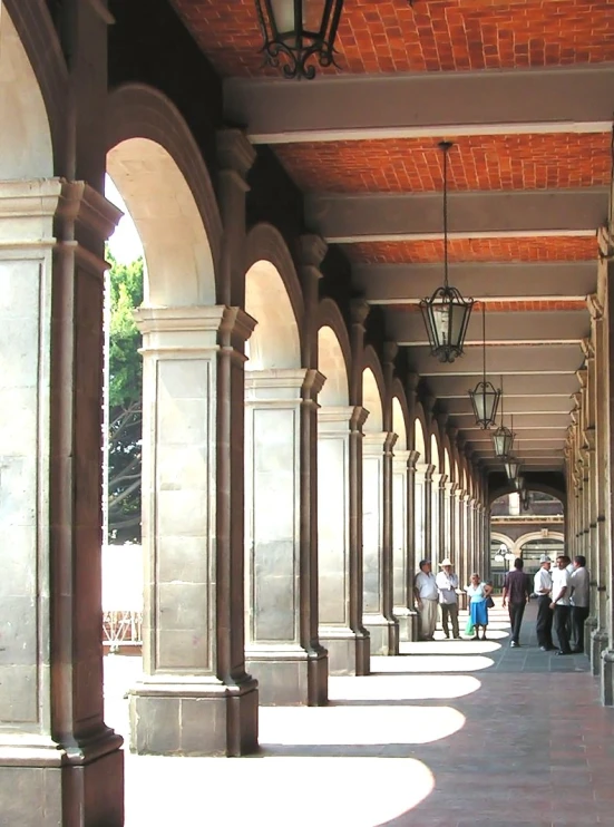 an outside view of people waiting at a bus stop