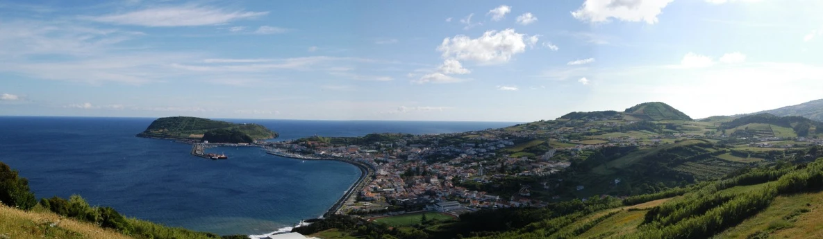 a view of some water from a hill side