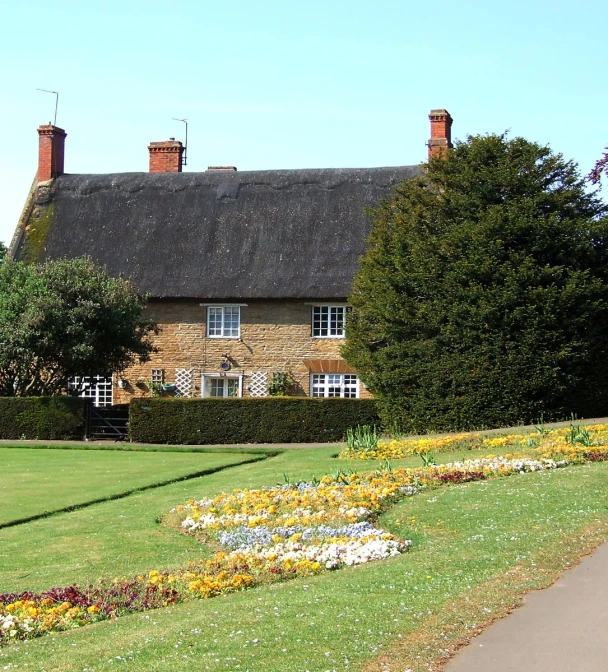 large house surrounded by greenery on a sunny day