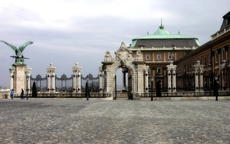 there is a gate and building at the middle of this street