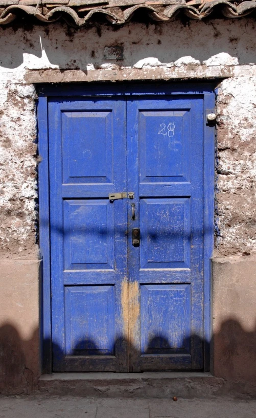 there are two blue doors that are on a wall