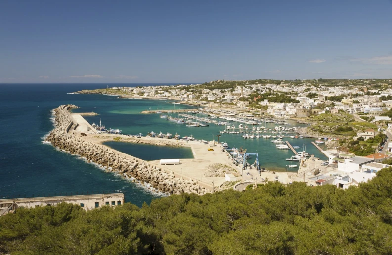 a small harbor next to the shoreline and a beach