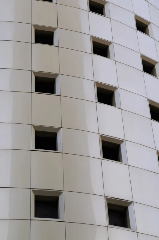 a tall white building with many windows on the side