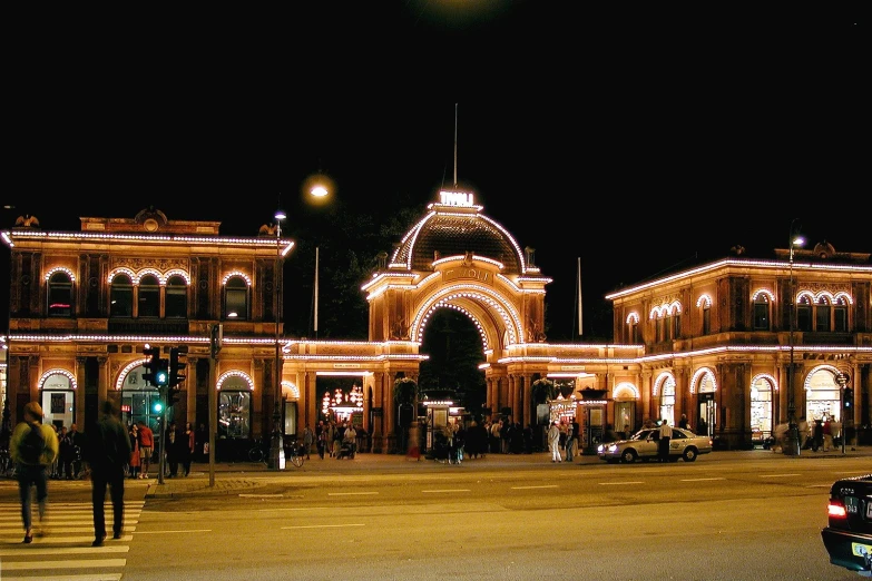 lights shine over an ornately decorated train station