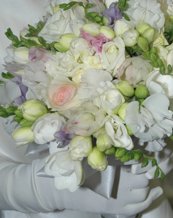 a bouquet of white and lavender flowers