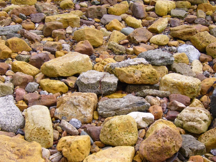 a large pile of rocks and gravel on a beach