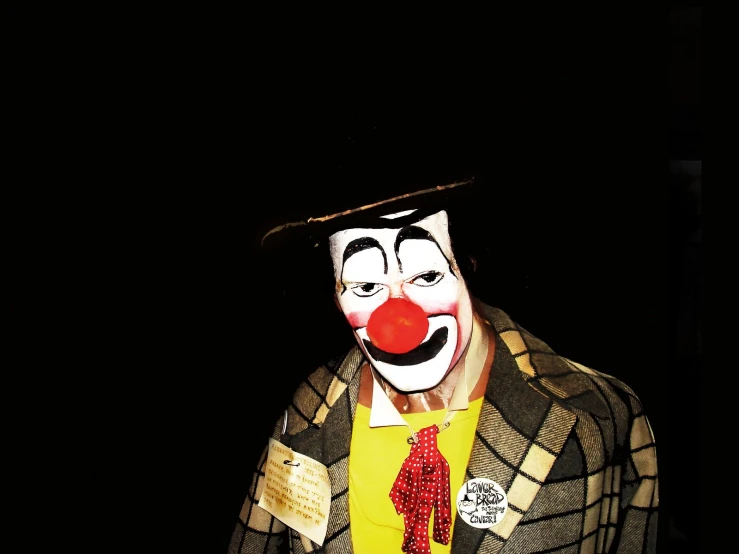 a clown with a top hat and jacket