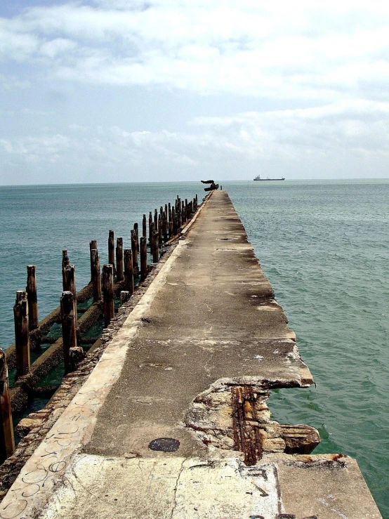 a large long dock stretching into the ocean