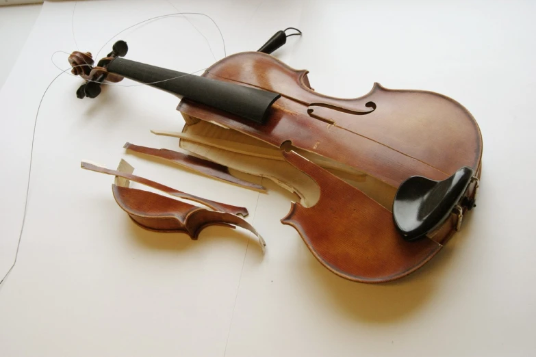 a violin that is sitting on a white table