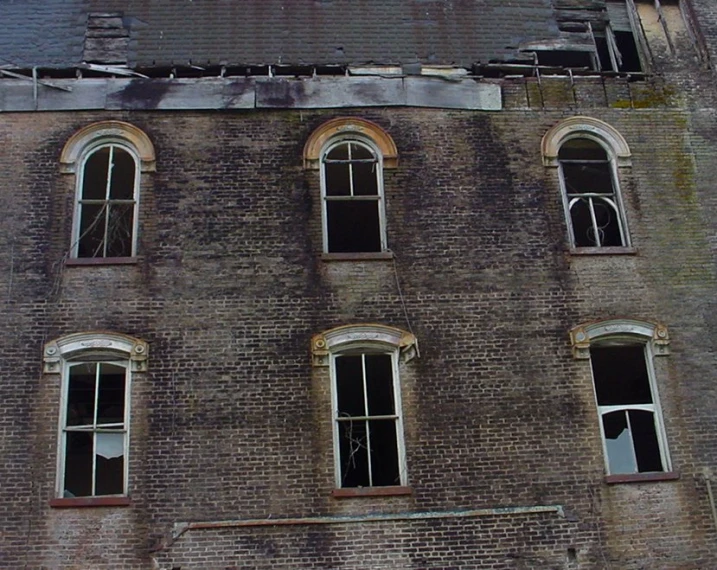 a worn and worn building with broken windows