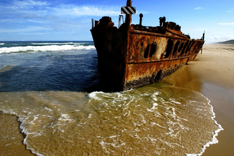 an old rusty ship washed up on the beach