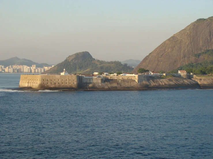 a view of water, mountains and a fort on an island