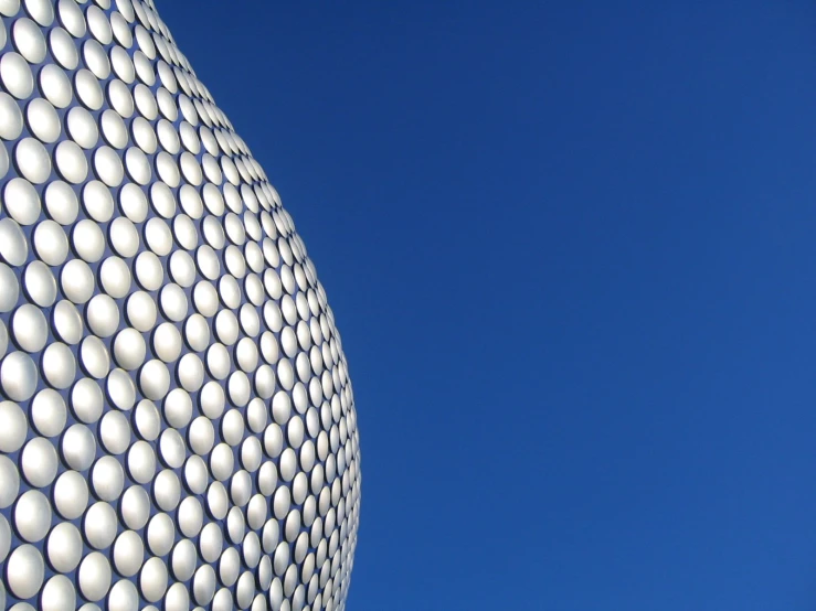 a modern, round structure with a wavy roof