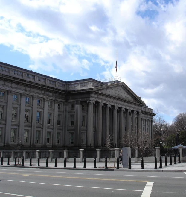 a stone building with columns at the bottom and top