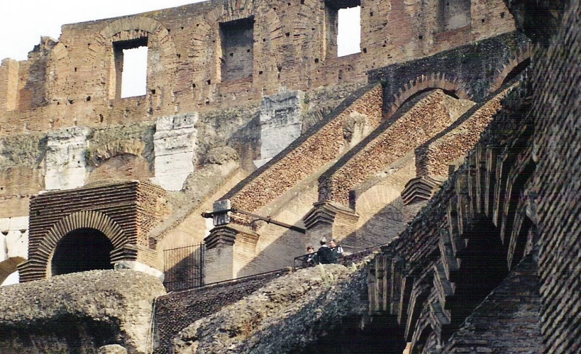 a brick structure with many windows and a roof top