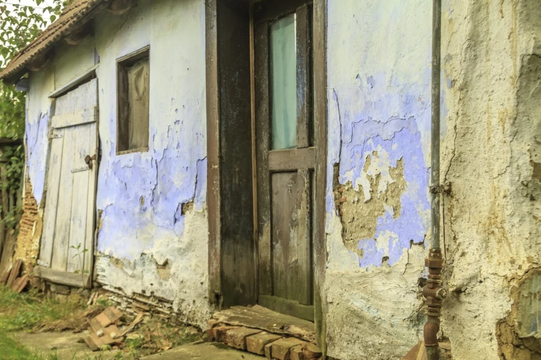 an old run down house that has faded paint