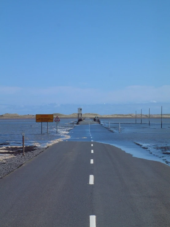 a long road that is connected to a body of water