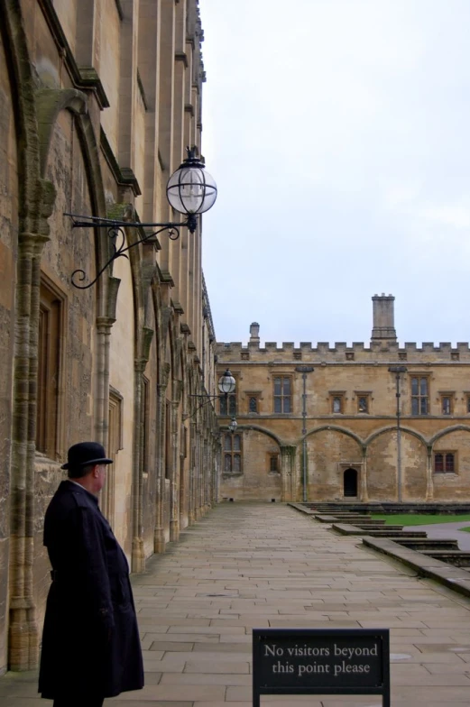 a man is standing outside of a large building