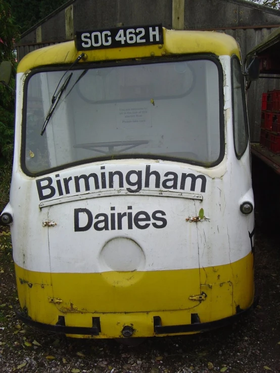 old yellow and white truck parked in a lot