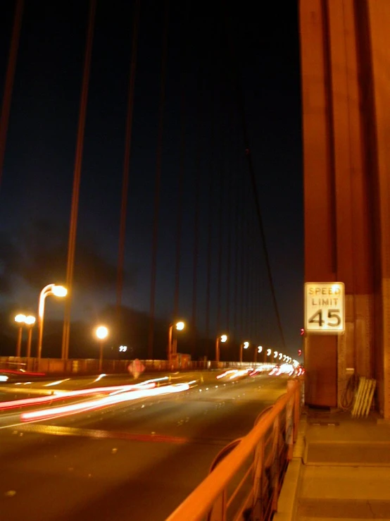 a night time picture of cars driving on the freeway