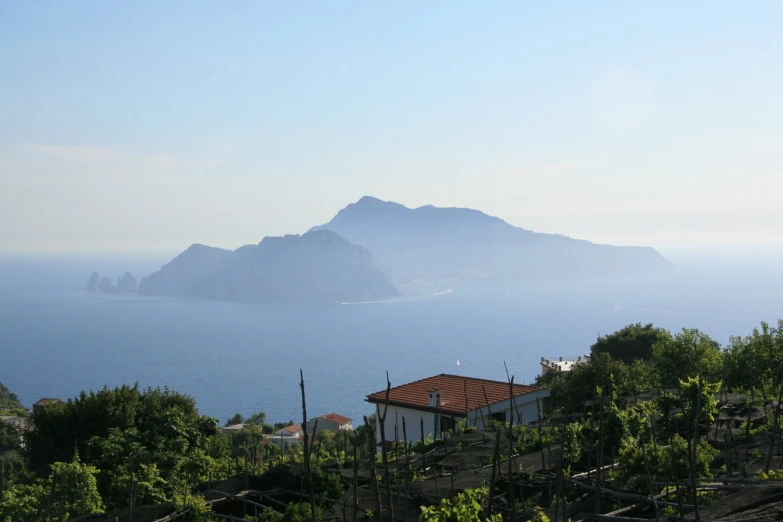 the mountains overlooking a large body of water with houses