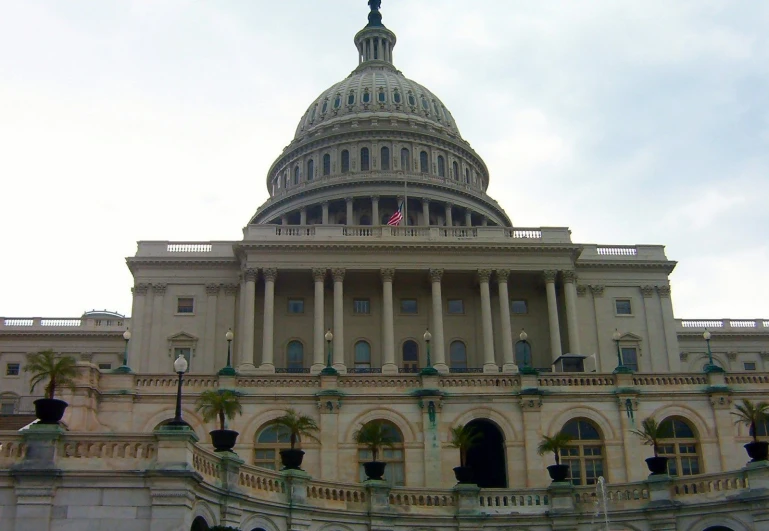 an old historic capitol building with a fountain in front