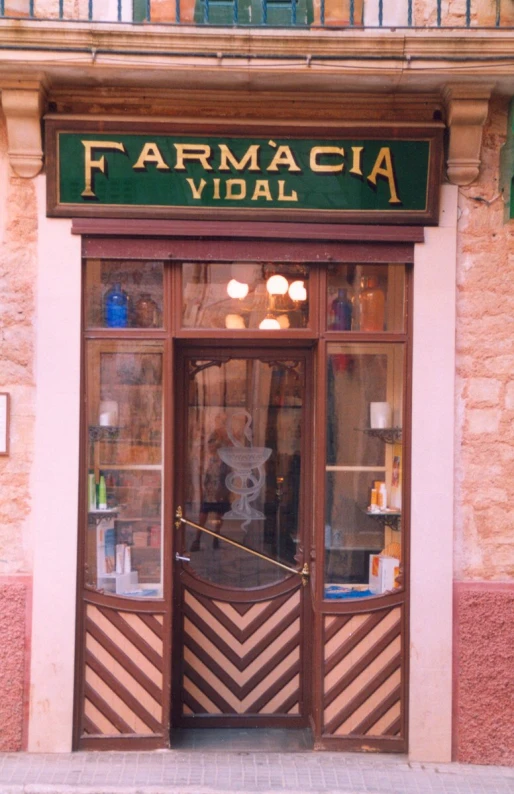 the front of an upscale store featuring a doorway with an iron curtain