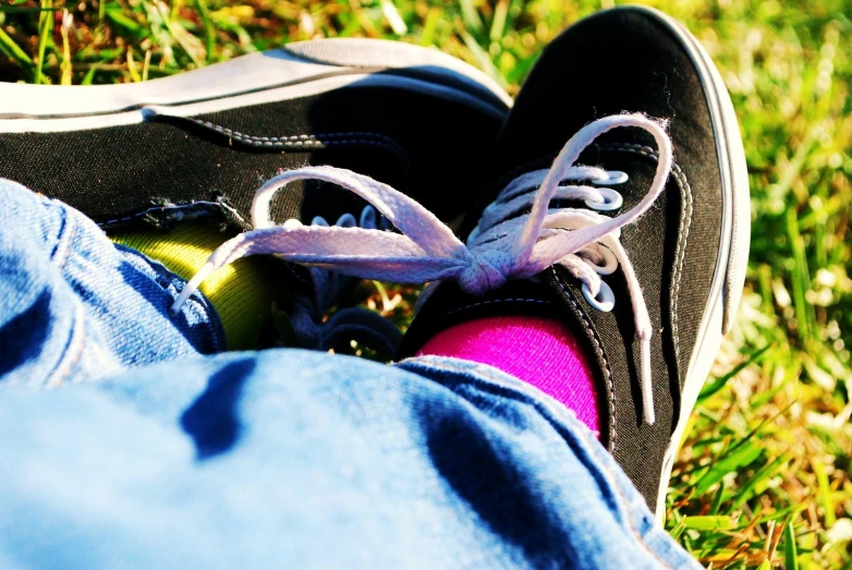 an image of a persons shoes on the grass