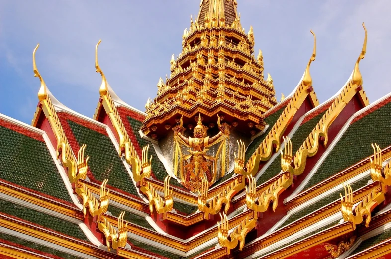 a large elaborate building with gold on the roof