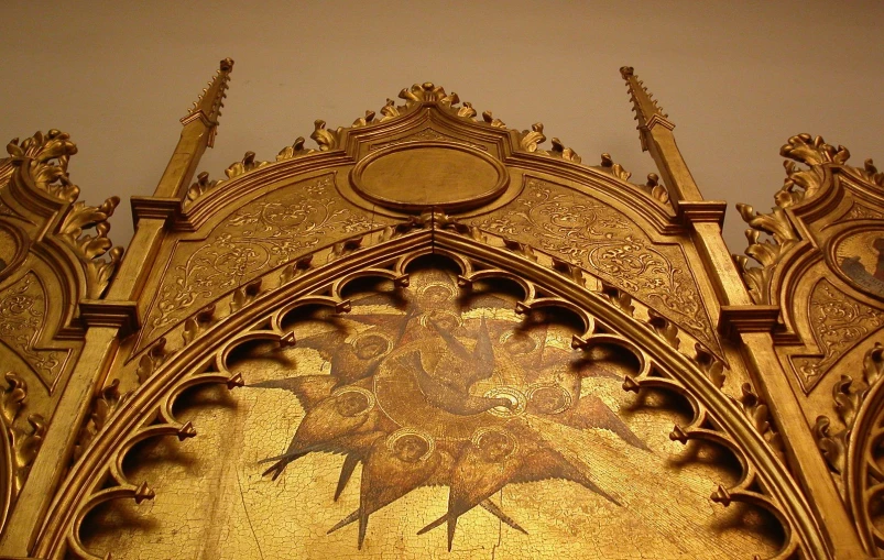 a fancy gold - colored mural covering the front of a building